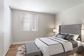Alameda apartment for rent - A bedroom with a large bed and a window with blinds.