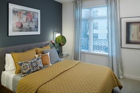 Oakland apartment for rent - a bedroom with a yellow bed and a window