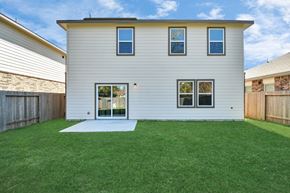 Houston apartment for rent - 4 Bedroom Single Family Homes for Rent in Houston TX - Imperial Forest - Back of a Home Exterior, with White Walls, Windows, Sliding Glass Back Door, and Grassy Lawns in a Fenced-In Yard