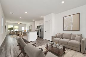 Houston apartment for rent - Five-Bedroom Single-Family Homes for Rent in Houston, TX - Imperial Forest - A Living Room with Wood-Style Flooring, Two Modern Armchairs, and a Glass Coffee Table.