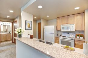 Seattle apartment for rent - a kitchen with white appliances and wooden cabinets