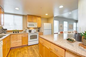 Seattle apartment for rent - a kitchen with white appliances and wooden cabinets