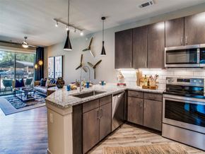 Grand Prairie apartment for rent - Apartments, Grand Prairie, TX - Waters Edge at Mansfield - Open Concept Living Room With A Leather Sofa, Coffee Table, Large Windows, Wall Art, And An Area Rug.