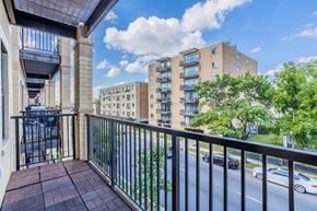 Chicago apartment for rent - a balcony with a view of a building and a street