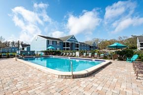Tampa apartment for rent - Pool with lounge chairs at The Commons apartments in Tampa, FL near downtown Tampa.