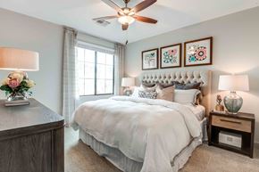 Chandler apartment for rent - Apartments for Rent Chandler, AZ - The Core Chandler - Bedroom With Tufted Upholstered Headboard, Large Window, Ceiling Fan, Soft Bedding, Nightstands, And Framed Wall Art.