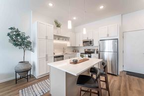 Eden Prairie apartment for rent - a white kitchen with stainless steel appliances and a white counter top