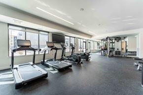 Eden Prairie apartment for rent - a gym with cardio equipment and windows in a building