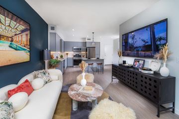 Las Vegas apartment for rent - A modern living room with a white sofa and a coffee table.