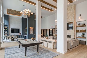 Dallas apartment for rent - A billiard table is in the middle of a living room.