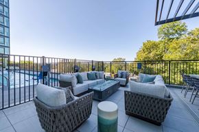Raleigh apartment for rent - A patio with a pool and a black fence.