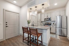 Midland apartment for rent - a kitchen with stainless steel appliances and white cabinets