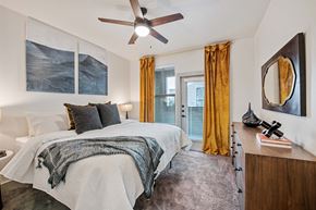 Midland apartment for rent - a bedroom with a large bed and a ceiling fan