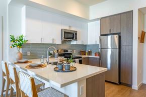 San Jose apartment for rent - A modern kitchen with a white countertop and stainless steel appliances.
