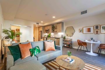 San Jose apartment for rent - A living room with a grey couch and a wooden coffee table.