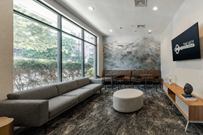 Stamford apartment for rent - A modern living room with a large window and a mountain mural on the wall.