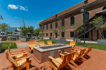 Stamford apartment for rent - A fire pit surrounded by wooden chairs in a courtyard.