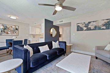 Tempe apartment for rent - A living room with a blue couch and a white coffee table.