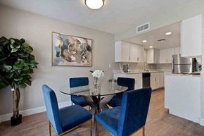 Tempe apartment for rent - A dining room with a glass table and blue chairs.