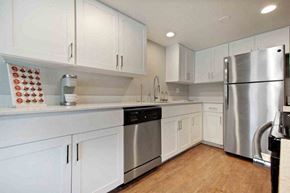 Tempe apartment for rent - A kitchen with white cabinets and a stainless steel refrigerator.