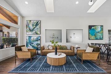 Henderson apartment for rent - A living room with a blue rug and a wooden coffee table.