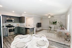 Parkville apartment for rent - A modern kitchen with a dining table set for two.