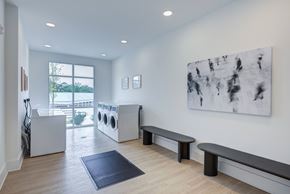 Clarkston apartment for rent - Bright resident laundry facility with modern washers, dryers, and folding space at Townes at Clarkston Centre apartments in Clarkston, GA.