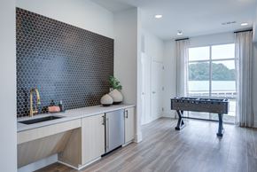 Clarkston apartment for rent - Resident entertainment lounge with kitchenette, coffee bar, and game area at Townes at Clarkston Centre apartments in Clarkston, GA.