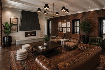 Yonkers apartment for rent - A living room with a brown leather couch and a fireplace.