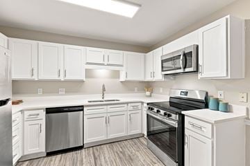 Hattiesburg apartment for rent - A kitchen with white cabinets and appliances.