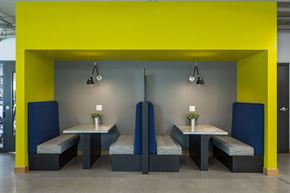 Minneapolis apartment for rent - a dining room with yellow and gray walls and tables with blue chairs