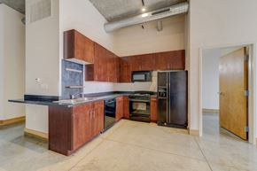 St. Louis apartment for rent - A kitchen with a black counter top and brown cabinets.