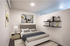 Portland apartment for rent - a bedroom with a bed and a painting on the wall