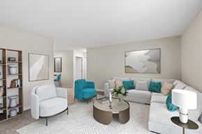 Eagan apartment for rent - A living room with a white couch, blue chair, and a coffee table.