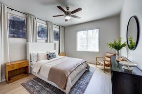 Henderson apartment for rent - A bedroom with a large bed and a ceiling fan.