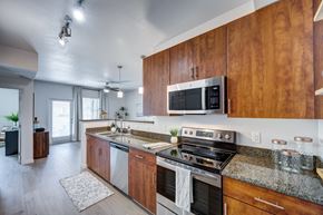 Henderson apartment for rent - A modern kitchen with wooden cabinets and stainless steel appliances.