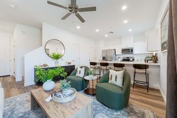 Tolleson apartment for rent - A living room with a green couch and a wooden coffee table.