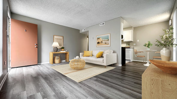 Denver apartment for rent - A living room with a white couch and a wooden coffee table.
