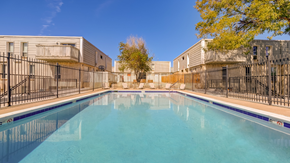 Denver apartment for rent - A swimming pool in a sunny day surrounded by a fence.