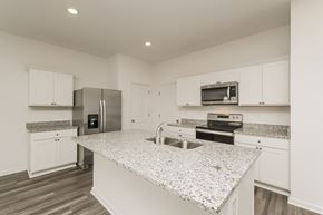 Zephyrhills apartment for rent - A kitchen with granite countertops and stainless steel appliances.