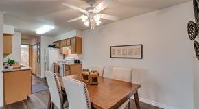 Spokane apartment for rent - Apartments in Spokane WA - Canyon Bluffs - Kitchen with Granite Countertops, White Appliances, a Well-Lit Dinning Area, and Wood Style Flooring