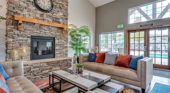Spokane apartment for rent - Apartments for Rent in Spokane, WA - Deer Creek - Clubhouse with Leather Sofas, Coffee Table, Fireplace, Glass-Paned Double Doors, and Large Windows.