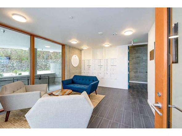 Seattle apartment for rent - Apartments Fremont, WA - Inspire Fremont - Lobby With Mail Boxes, Coffee Table, Lounge Seating, Natural Fiber Rug, And Modern Lighting.