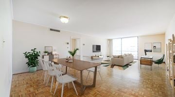 Washington apartment for rent - A living room with a brown table and white chairs.