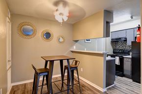 Houston apartment for rent - a kitchen and dining area with two stools and a counter top