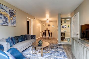 Houston apartment for rent - A living room with a white couch and blue chairs.