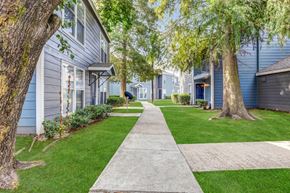 Gretna apartment for rent - Whitney Manor Apartments in Gretna, LA photo of community buildings with greenery in between