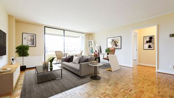 Washington apartment for rent - A living room with a grey sofa and a glass coffee table.