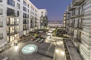 Oakland apartment for rent - A rooftop patio with a hot tub and a view of the water.