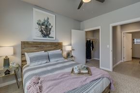 Tigard apartment for rent - Tigard, OR Apartments for Rent - Sygnii - Bedroom with Carpet Flooring, a Spacious Closet, and a Ceiling Fan